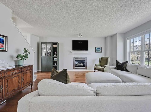 558 Evermeadow Road Sw, Calgary, AB - Indoor Photo Showing Living Room With Fireplace