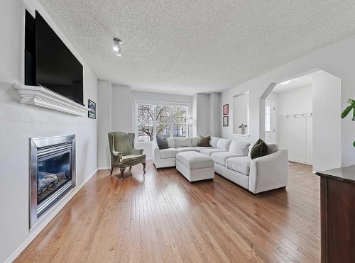 558 Evermeadow Road Sw, Calgary, AB - Indoor Photo Showing Living Room With Fireplace