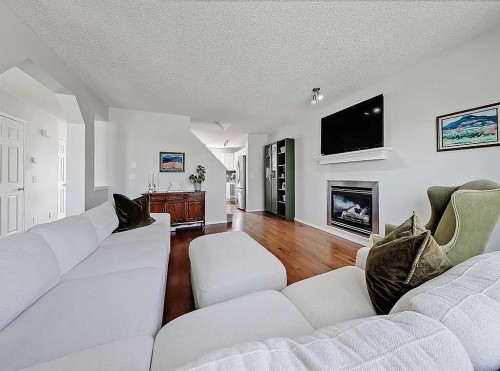558 Evermeadow Road Sw, Calgary, AB - Indoor Photo Showing Living Room With Fireplace
