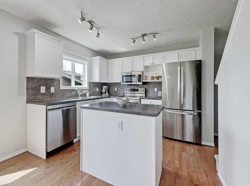 558 Evermeadow Road Sw, Calgary, AB - Indoor Photo Showing Kitchen With Double Sink
