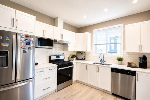 102-130 Redstone Ne, Calgary, AB - Indoor Photo Showing Kitchen With Double Sink With Upgraded Kitchen