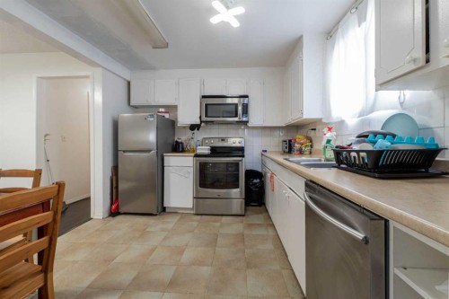 27 Erin Grove Court Se, Calgary, AB - Indoor Photo Showing Kitchen With Double Sink