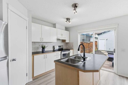 30 Tuscany Springs Heights Nw, Calgary, AB - Indoor Photo Showing Kitchen With Double Sink