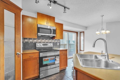 141 Cramond Close Se, Calgary, AB - Indoor Photo Showing Kitchen With Double Sink