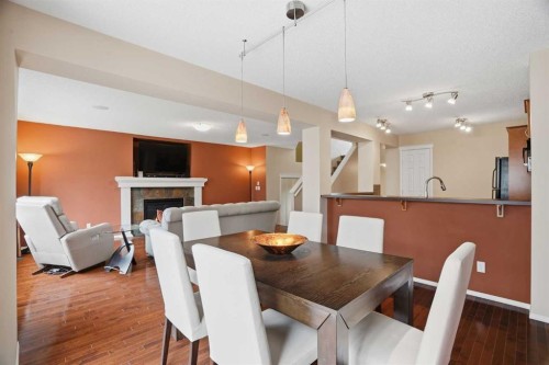 56 Everglen Way Sw, Calgary, AB - Indoor Photo Showing Dining Room With Fireplace
