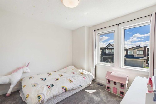 59 Royston Rise Nw, Calgary, AB - Indoor Photo Showing Bedroom