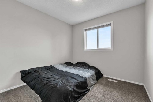 242 Copperstone Grove Se, Calgary, AB - Indoor Photo Showing Bedroom