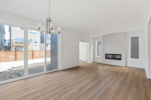 486 Lucas Way Nw, Calgary, AB - Indoor Photo Showing Living Room With Fireplace