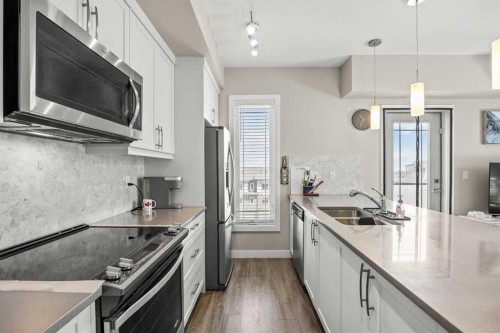 401-150 Auburn Meadows Manor Se, Calgary, AB - Indoor Photo Showing Kitchen With Stainless Steel Kitchen With Double Sink With Upgraded Kitchen