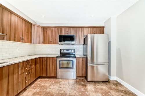553 Windstone Common Sw, Airdrie, AB - Indoor Photo Showing Kitchen With Stainless Steel Kitchen