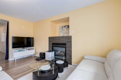 324 Evermeadow Road Sw, Calgary, AB - Indoor Photo Showing Living Room With Fireplace