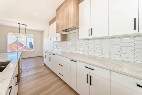 407 Rivercrest Road, Cochrane, AB - Indoor Photo Showing Kitchen With Double Sink