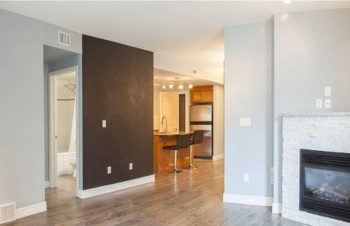 601-910 5 Avenue Sw, Calgary, AB - Indoor Photo Showing Living Room With Fireplace