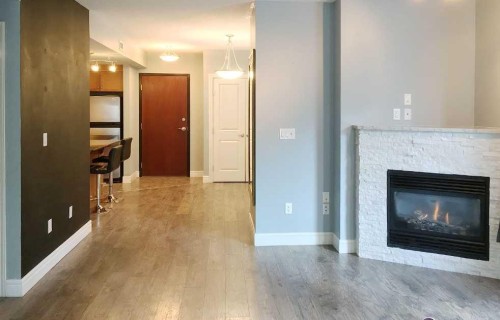 601-910 5 Avenue Sw, Calgary, AB - Indoor Photo Showing Living Room With Fireplace