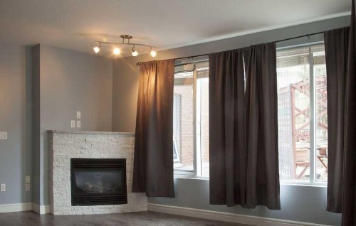 601-910 5 Avenue Sw, Calgary, AB - Indoor Photo Showing Living Room With Fireplace