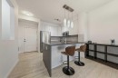 404-207 Sunset Drive, Cochrane, AB  - Indoor Photo Showing Kitchen With Upgraded Kitchen 