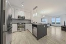 404-207 Sunset Drive, Cochrane, AB  - Indoor Photo Showing Kitchen With Upgraded Kitchen 