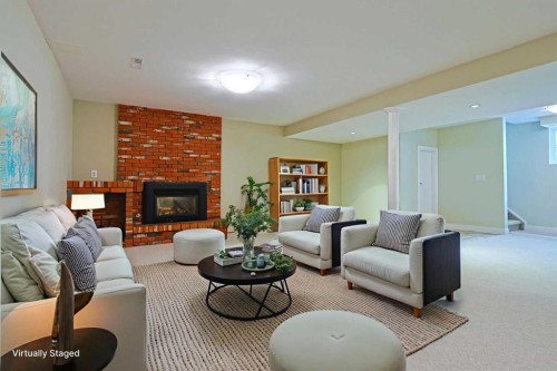 175 Brabourne Road Sw, Calgary, AB - Indoor Photo Showing Living Room With Fireplace