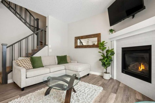 183 Kinniburgh Road, Chestermere, AB - Indoor Photo Showing Living Room With Fireplace