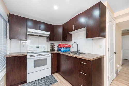 138 Panamount Crescent Nw, Calgary, AB - Indoor Photo Showing Kitchen With Double Sink