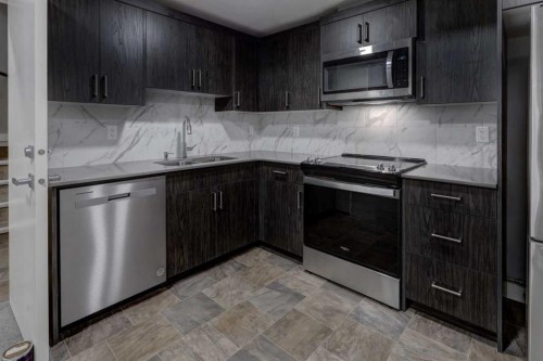 154 Amblehurst Way Nw, Calgary, AB - Indoor Photo Showing Kitchen With Double Sink With Upgraded Kitchen