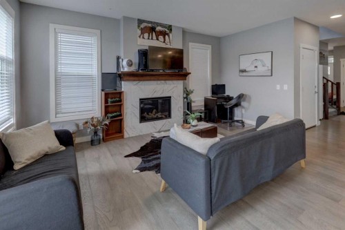 154 Amblehurst Way Nw, Calgary, AB - Indoor Photo Showing Living Room With Fireplace