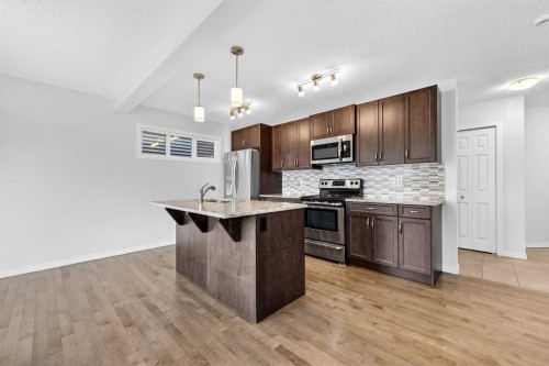 99 Buckskin Way, Cochrane, AB - Indoor Photo Showing Kitchen With Upgraded Kitchen
