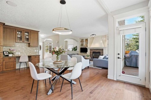 149 Aspen Glen Place Sw, Calgary, AB - Indoor Photo Showing Dining Room With Fireplace