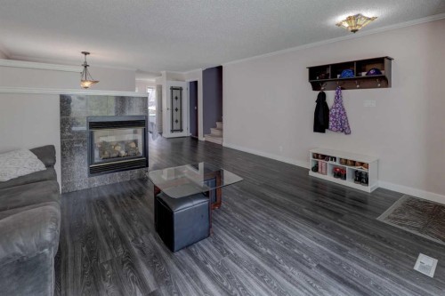 36 Hawksley Crescent Nw, Calgary, AB - Indoor Photo Showing Living Room With Fireplace