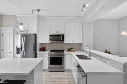 242 Livingston Common Ne, Calgary, AB - Indoor Photo Showing Kitchen With Stainless Steel Kitchen With Double Sink With Upgraded Kitchen