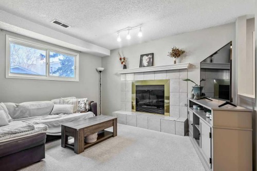 52 Hunters Crescent, Okotoks, AB - Indoor Photo Showing Living Room With Fireplace