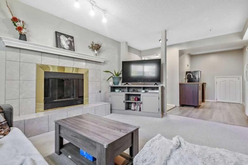 52 Hunters Crescent, Okotoks, AB - Indoor Photo Showing Living Room With Fireplace