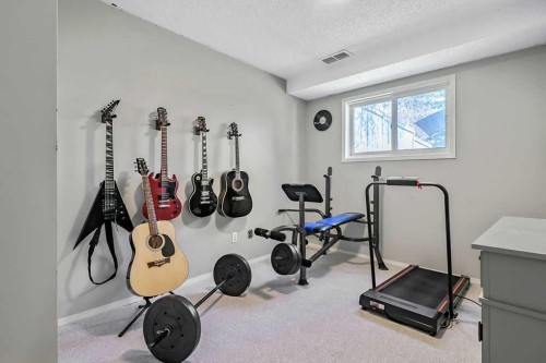 52 Hunters Crescent, Okotoks, AB - Indoor Photo Showing Gym Room