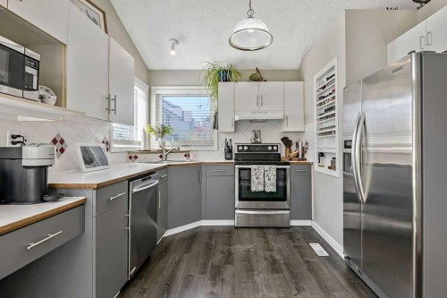 52 Hunters Crescent, Okotoks, AB - Indoor Photo Showing Kitchen With Double Sink With Upgraded Kitchen