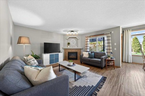 152 Chapman Close Se, Calgary, AB - Indoor Photo Showing Living Room With Fireplace