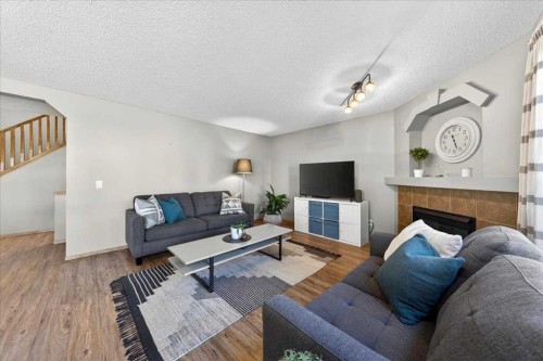152 Chapman Close Se, Calgary, AB - Indoor Photo Showing Living Room With Fireplace