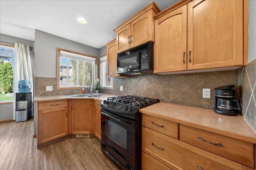 152 Chapman Close Se, Calgary, AB - Indoor Photo Showing Kitchen With Double Sink