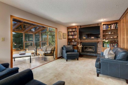 2724 Palliser Drive Sw, Calgary, AB - Indoor Photo Showing Living Room With Fireplace
