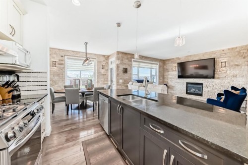 89 Evansdale Landing Nw, Calgary, AB - Indoor Photo Showing Kitchen With Fireplace With Double Sink With Upgraded Kitchen