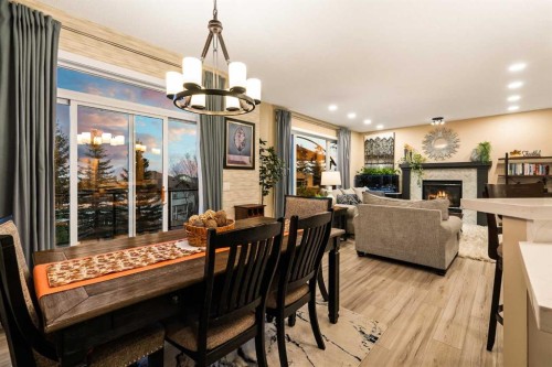 62 Panamount View Nw, Calgary, AB - Indoor Photo Showing Dining Room With Fireplace