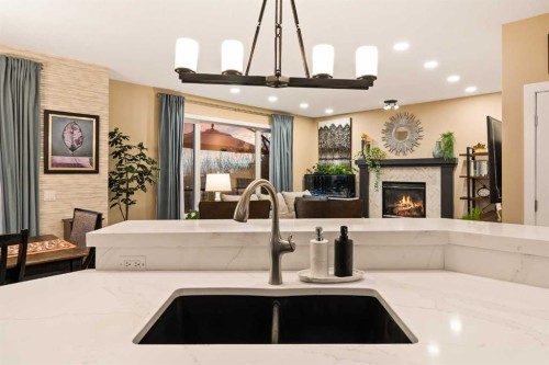 62 Panamount View Nw, Calgary, AB - Indoor Photo Showing Kitchen With Fireplace With Double Sink