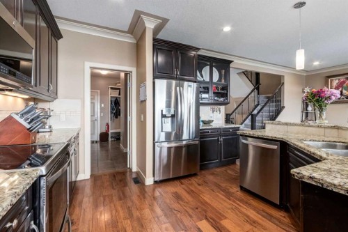 7 Sunset Way, Cochrane, AB - Indoor Photo Showing Kitchen With Stainless Steel Kitchen With Double Sink With Upgraded Kitchen