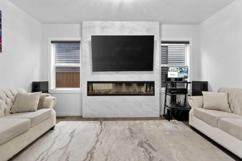 49 Redstone Heath Ne, Calgary, AB - Indoor Photo Showing Living Room With Fireplace