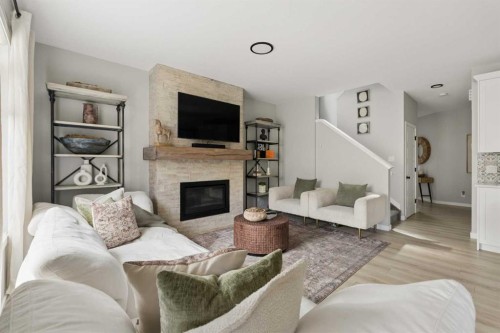 630 Kingsmere Way Se, Airdrie, AB - Indoor Photo Showing Living Room With Fireplace