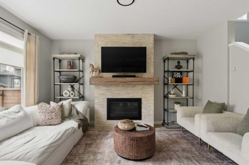 630 Kingsmere Way Se, Airdrie, AB - Indoor Photo Showing Living Room With Fireplace