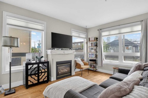 205-2 14 Street Nw, Calgary, AB - Indoor Photo Showing Living Room With Fireplace