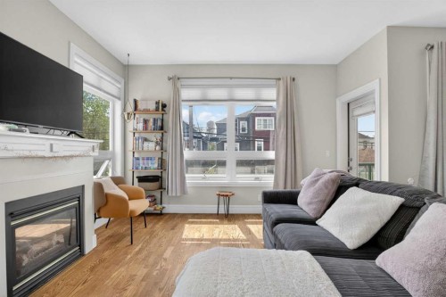 205-2 14 Street Nw, Calgary, AB - Indoor Photo Showing Living Room With Fireplace