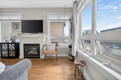 205-2 14 Street Nw, Calgary, AB - Indoor Photo Showing Living Room With Fireplace