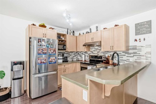 65 Spring Meadows Bay, Okotoks, AB - Indoor Photo Showing Kitchen With Double Sink