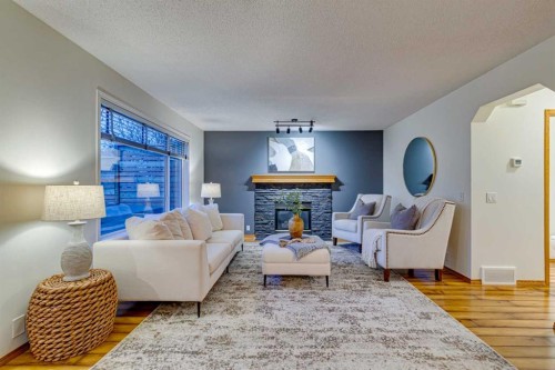268 Mt Brewster Circle Se, Calgary, AB - Indoor Photo Showing Living Room With Fireplace